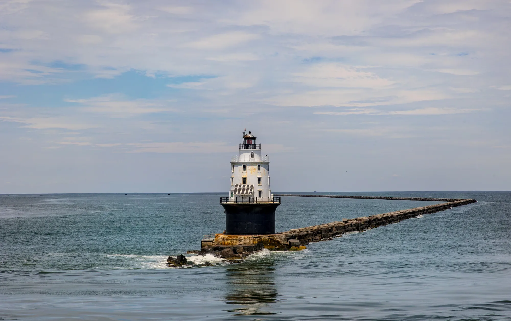 Historic coastal lighthouse standing against the open sea