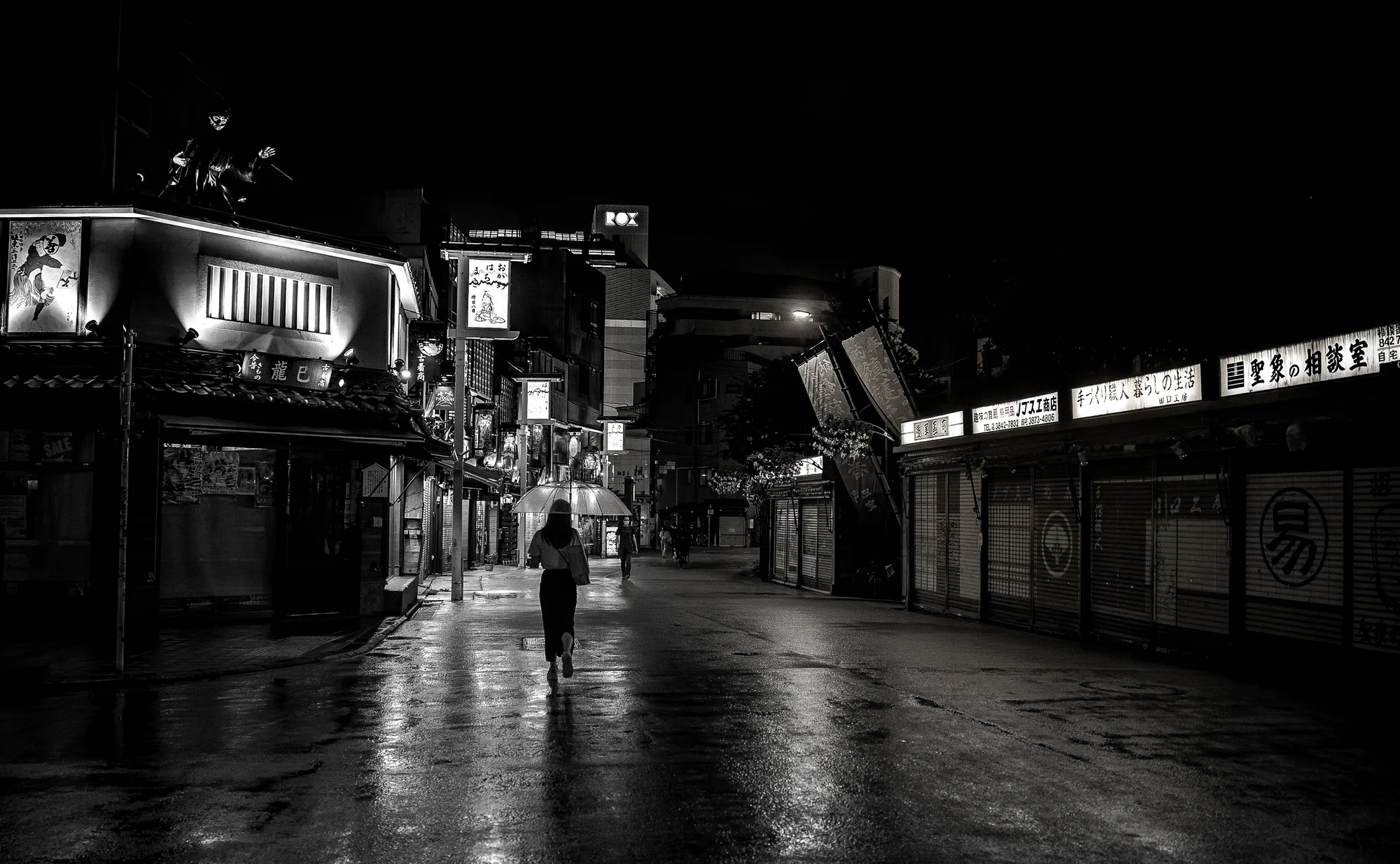 Asakusa streets illuminated by rain and neon lights