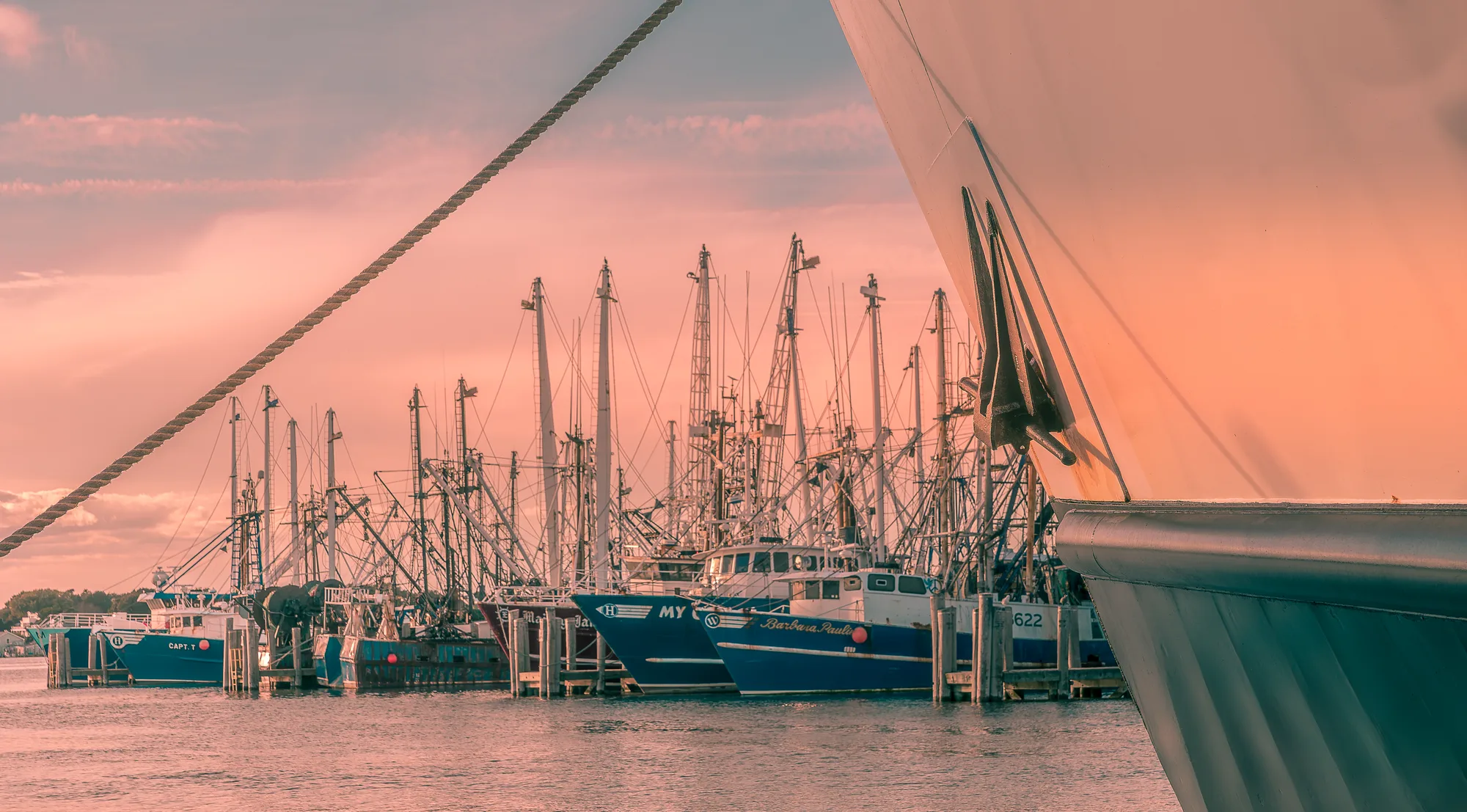 Harbor boats anchored in calm coastal inlet