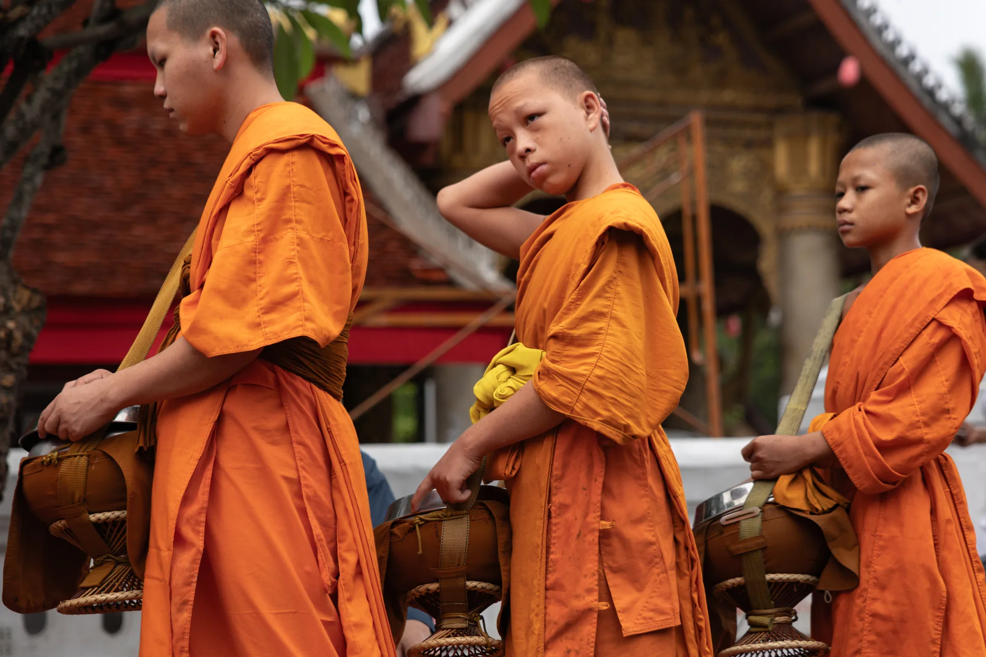 Three young Buddhist monks walking together